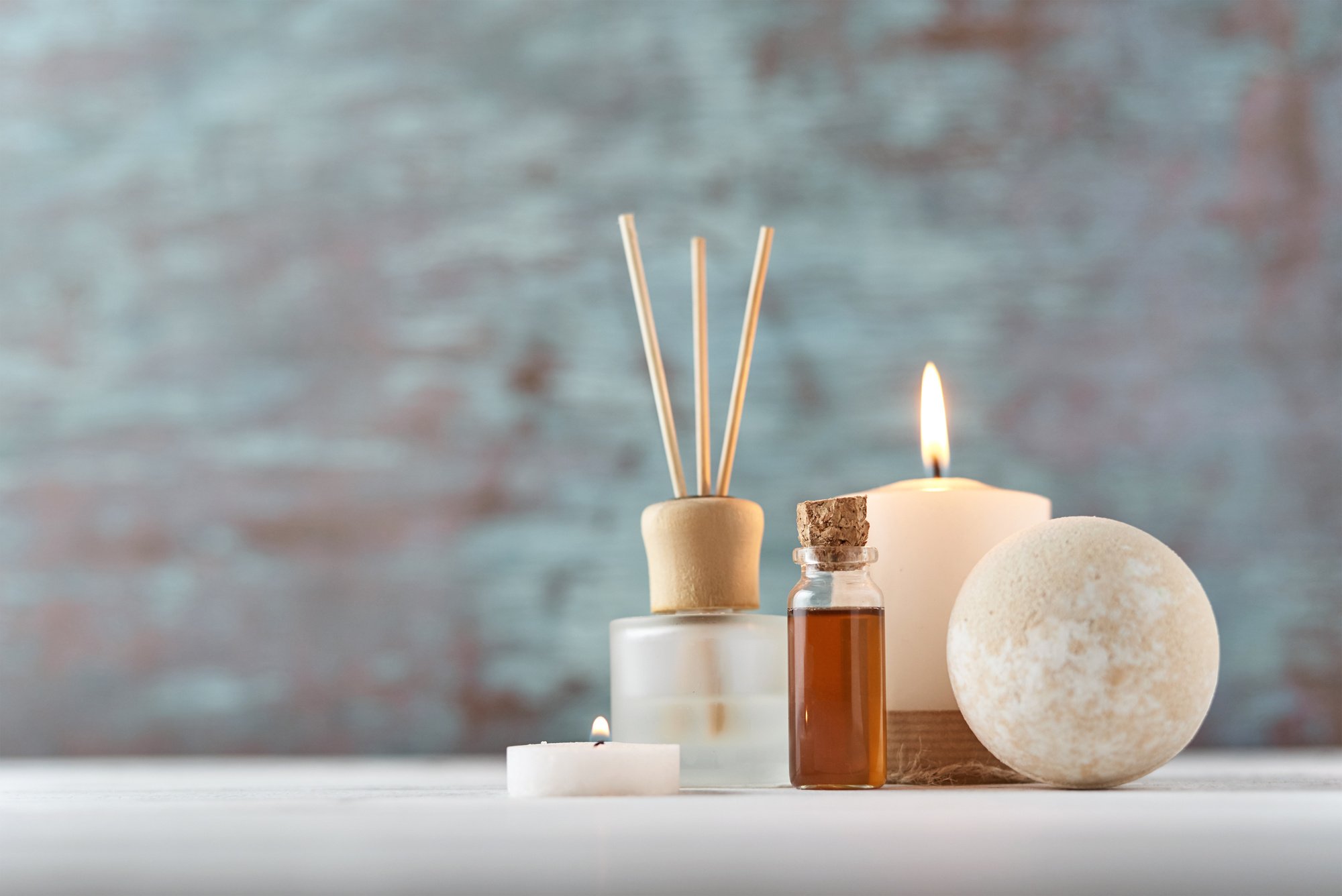 Candle and Massage Oil on White Table